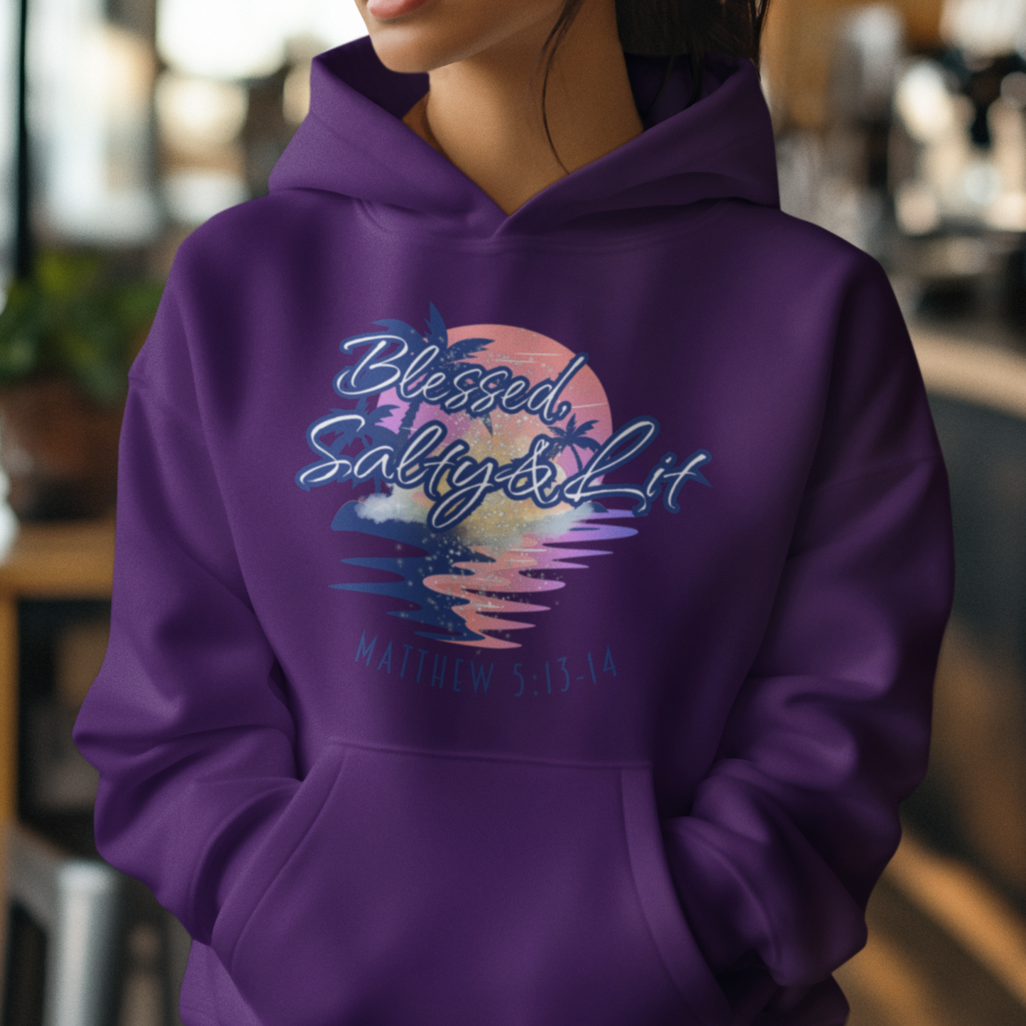 Person wearing a purple hoodie with a colorful design and text.