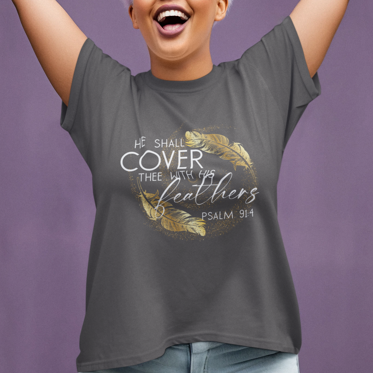 Woman wearing a gray t-shirt with a design and text, raising her arms against a purple background