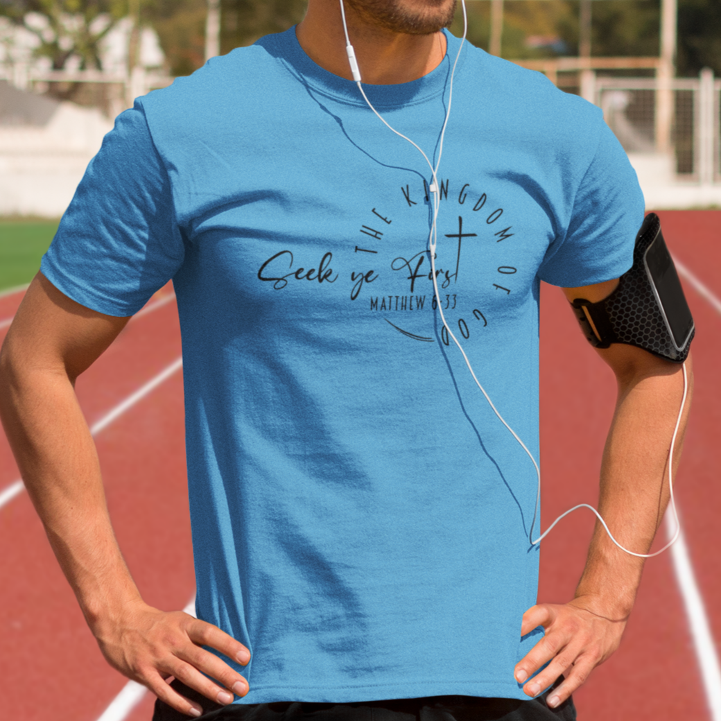 Man wearing a blue t-shirt with text on a running track