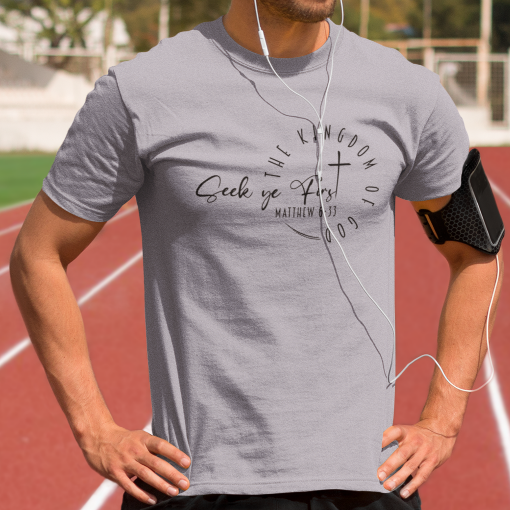 Man wearing a gray t-shirt with text on a running track