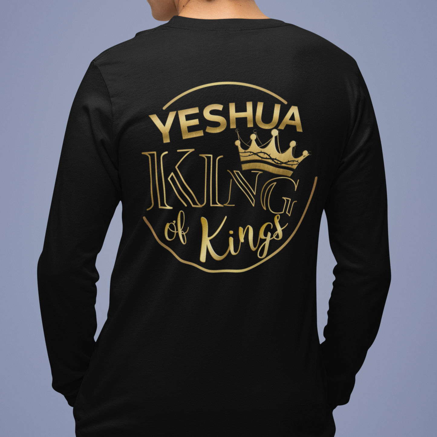 Person wearing a black long-sleeve shirt with 'Yeshua King of Kings' text on the back against a blue background
