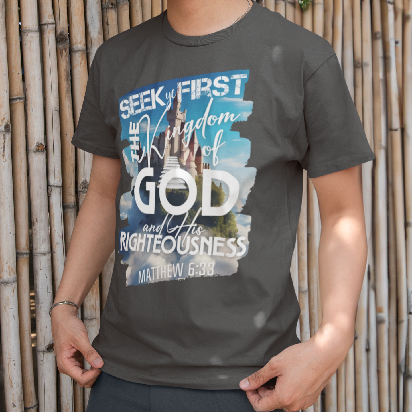 Person wearing a t-shirt with a motivational quote against a bamboo wall