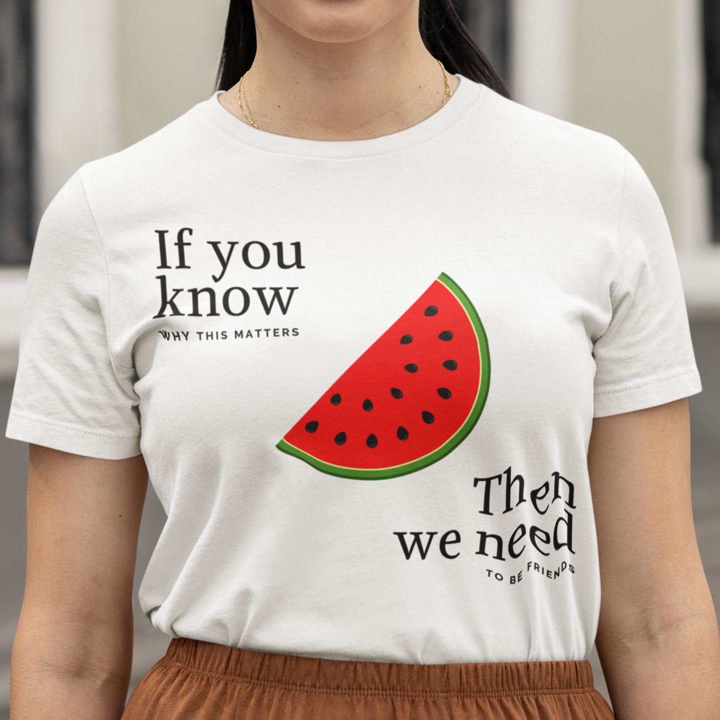 Woman wearing a white t-shirt with a watermelon slice graphic and text.