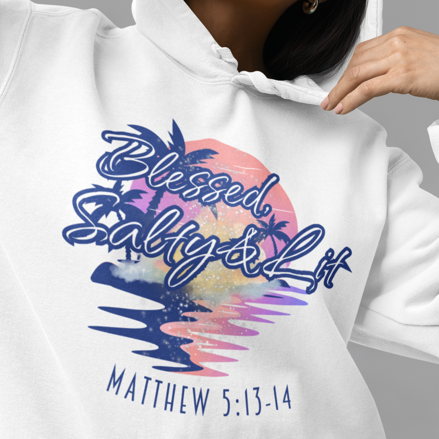 White hoodie with 'Blessed, Salty & Lit' design and Matthew 5:13-14 text on a gray background