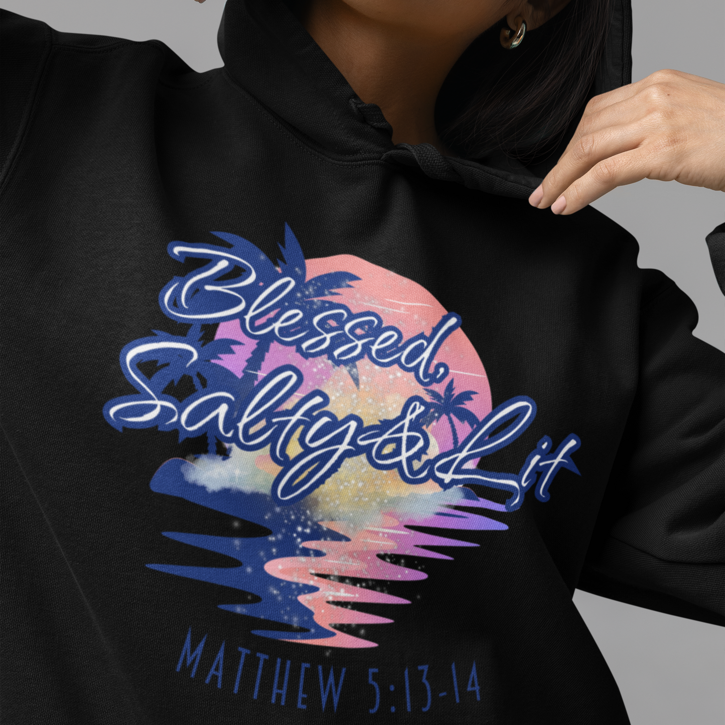 Black hoodie with colorful graphic and text, worn by a person.