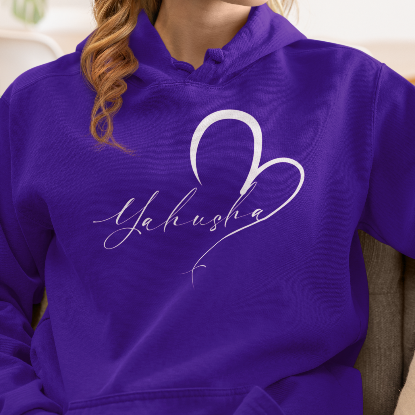 Person wearing a purple hoodie with 'Yahusha' design