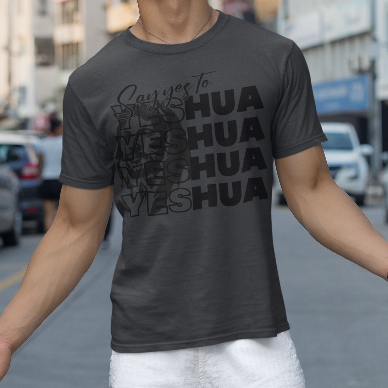 Man wearing a black t-shirt with text on a city street