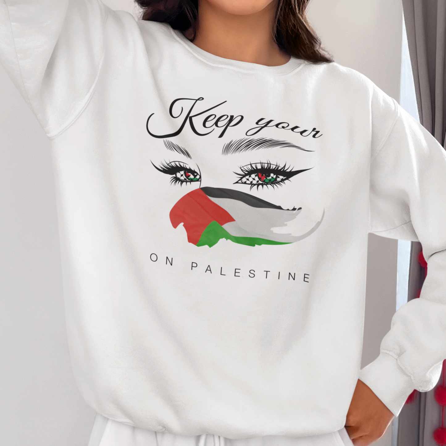 Person wearing a white sweatshirt with a design and text, standing against a neutral background.
