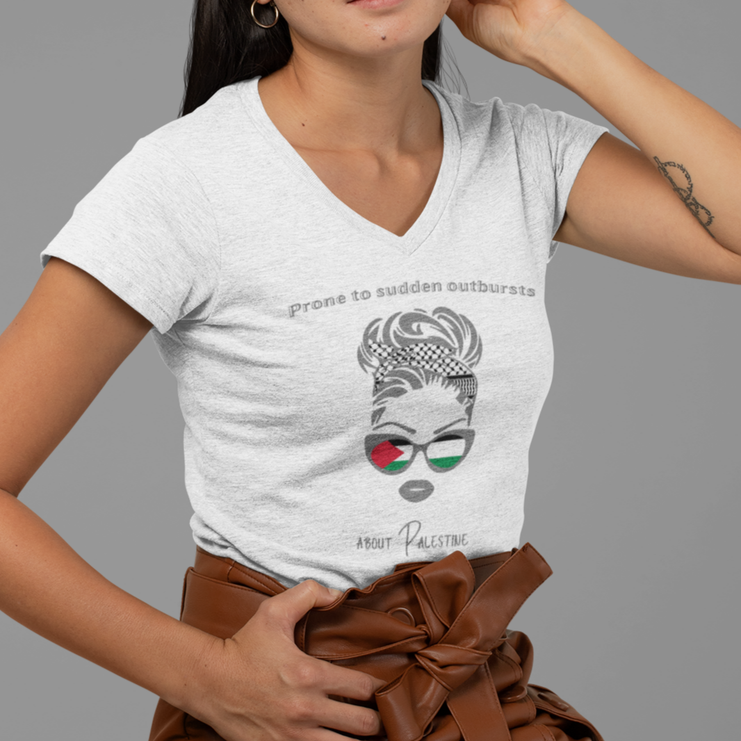 Woman wearing a white t-shirt with a graphic design and a brown leather skirt on a gray background
