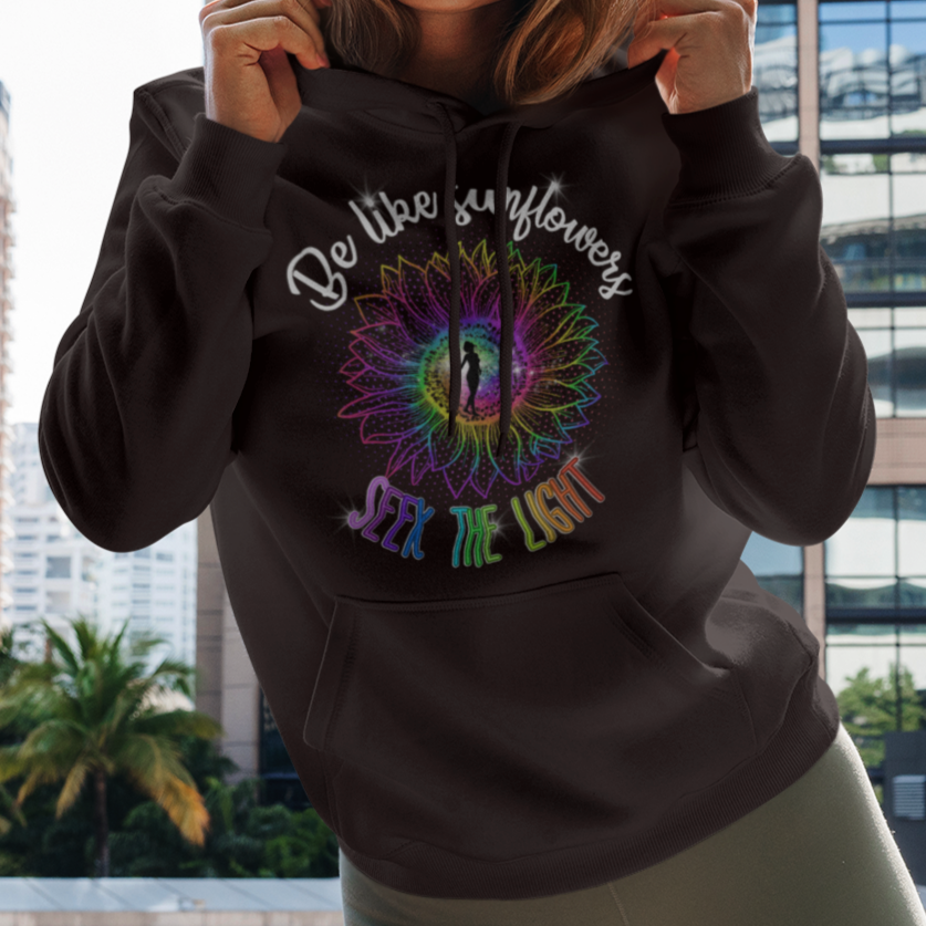 Woman wearing a hoodie with a colorful design in an urban setting
