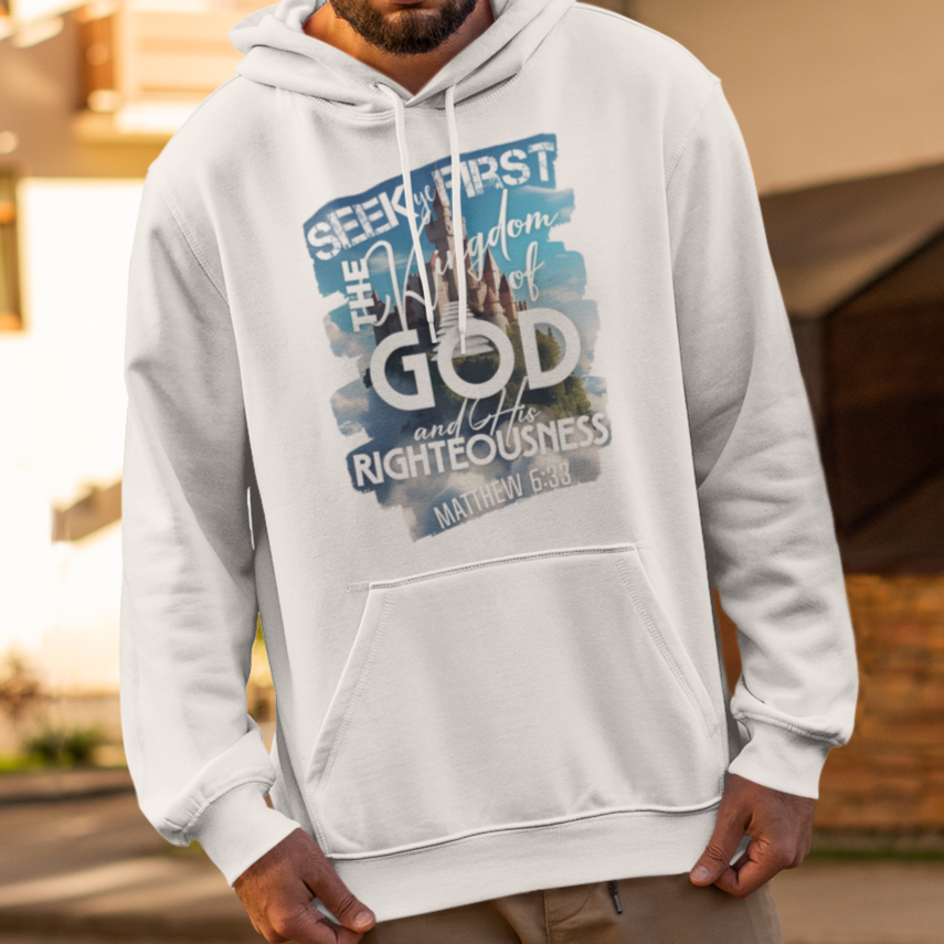 Man wearing a white hoodie with text and graphics, standing on a street.