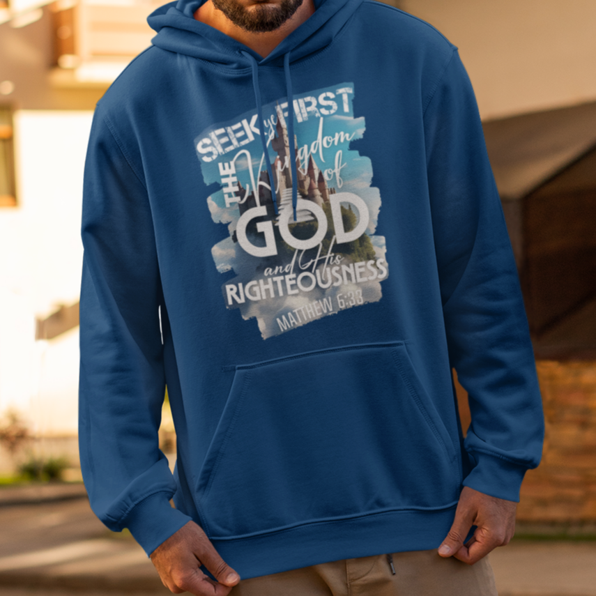 Man wearing a blue hoodie with text on it, standing on a street.
