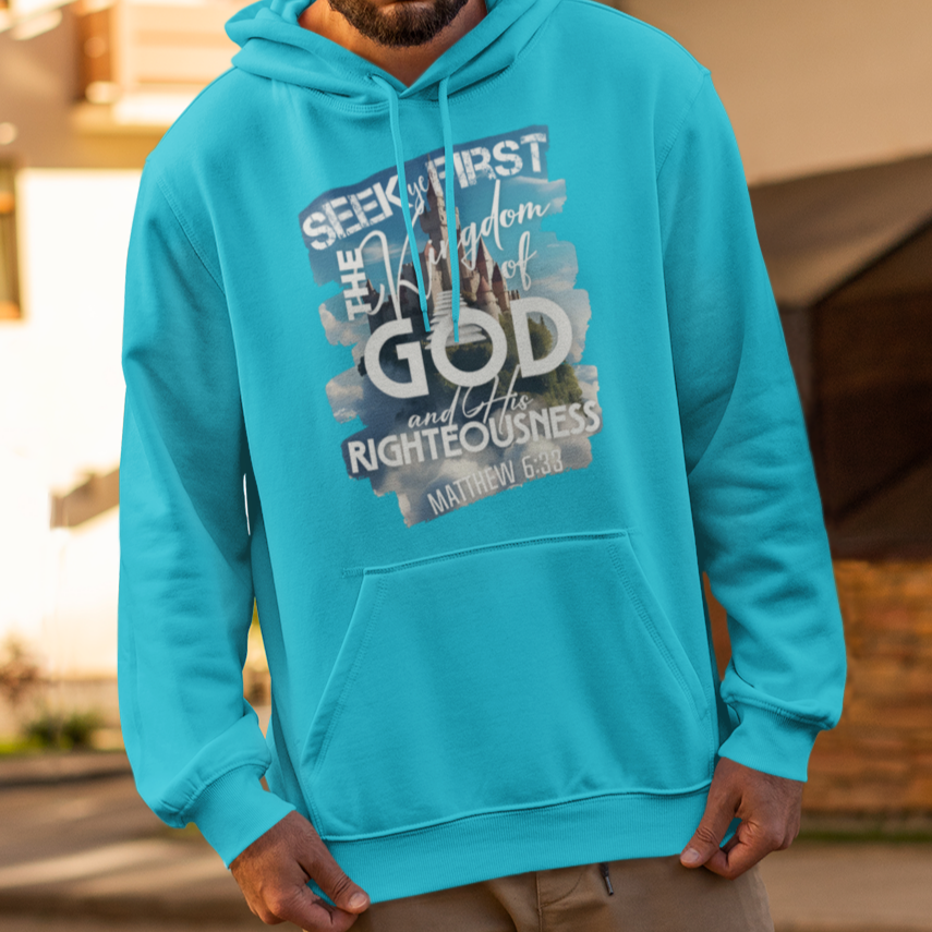 Man wearing a turquoise hoodie with text on it, standing on a street.