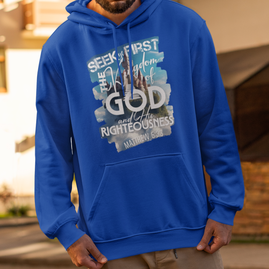Man wearing a blue hoodie with text and graphics on a street.