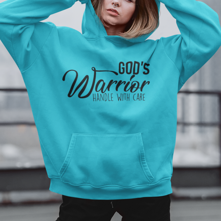 Person wearing a turquoise hoodie with text, standing on a rooftop.