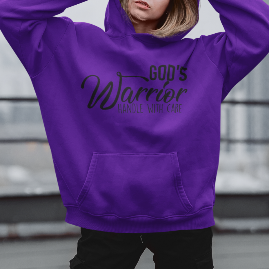 Person wearing a purple hoodie with text, standing on a rooftop.