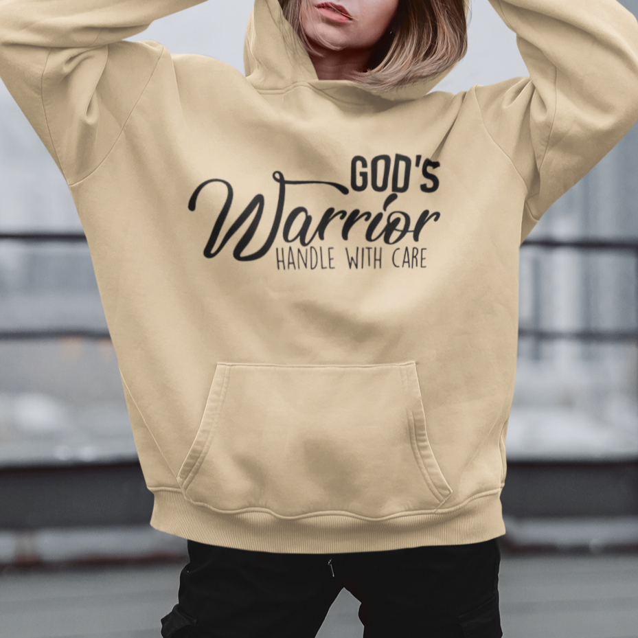 Person wearing a beige hoodie with text on it, standing on a rooftop.