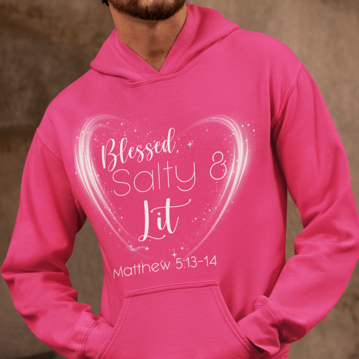 Person wearing a pink hoodie with a heart design and text.