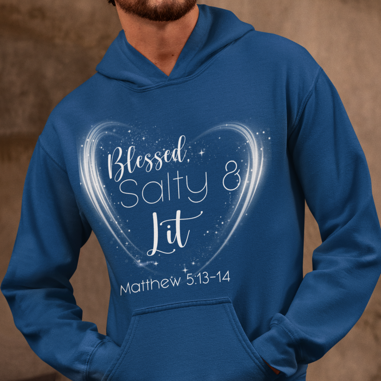 Person wearing a blue hoodie with a heart design and text on a brown background