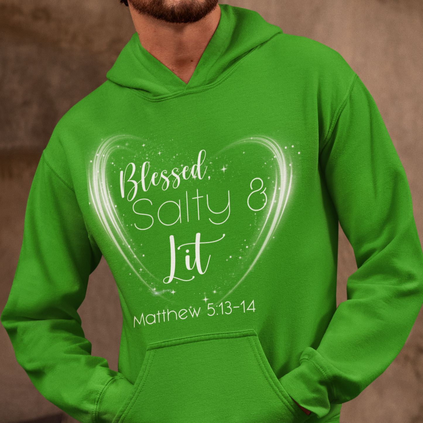 Green hoodie with text design worn by a person against a brown background