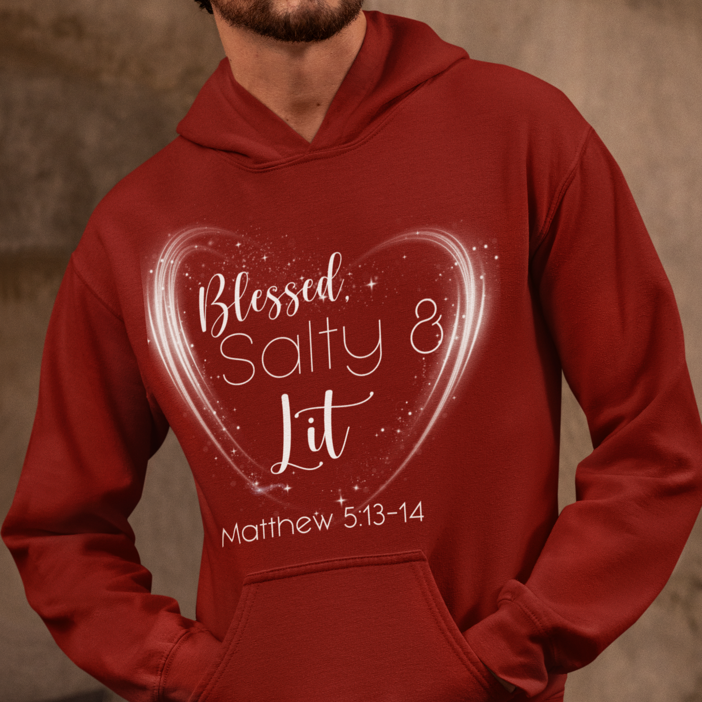 Red hoodie with 'Blessed, Salty & Lit' text and heart design worn by a person.