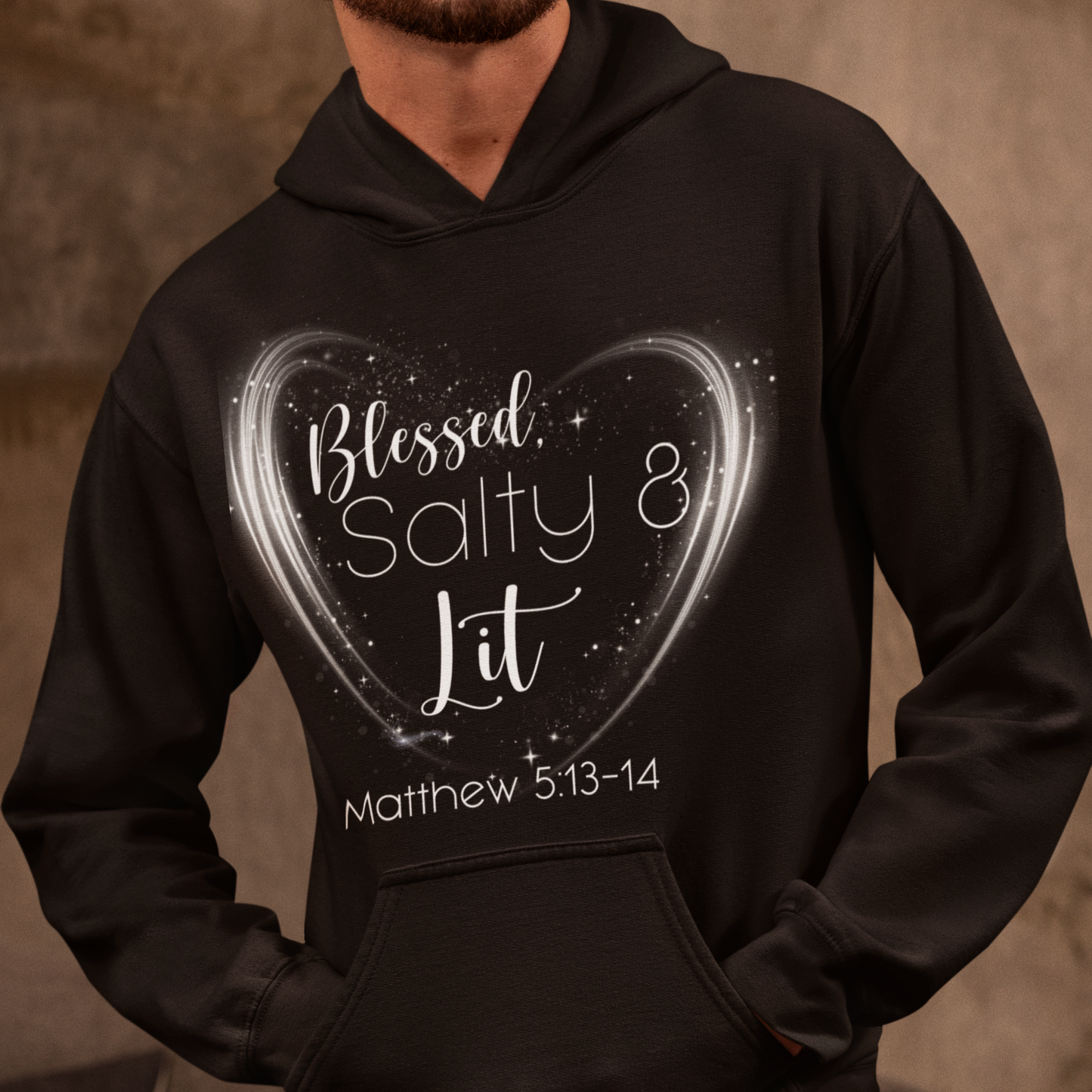 Person wearing a black hoodie with 'Blessed Salty & Lit' text and heart design.