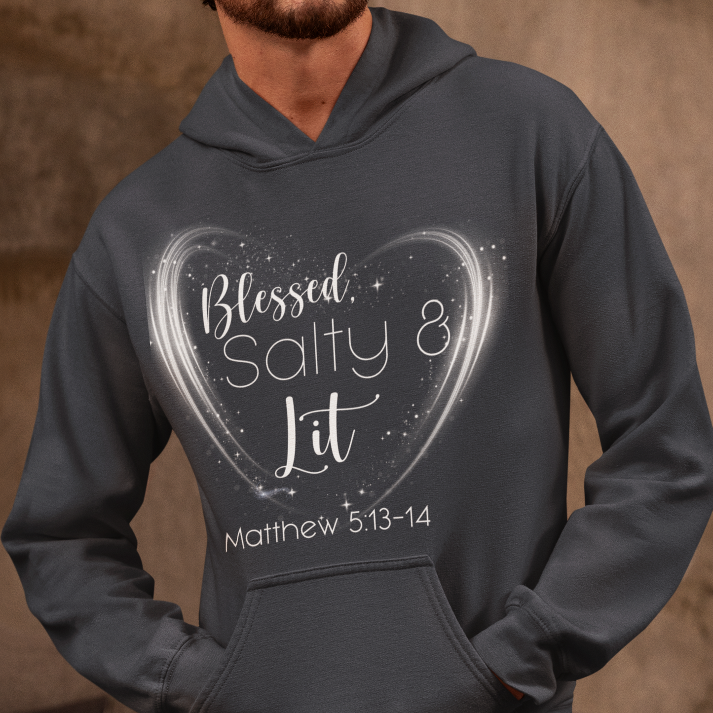 Person wearing a dark gray hoodie with a heart design and text on a brown background