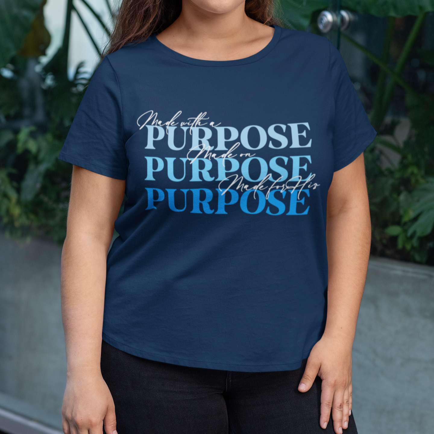 Person wearing a blue t-shirt with 'Purpose' text, standing outdoors.