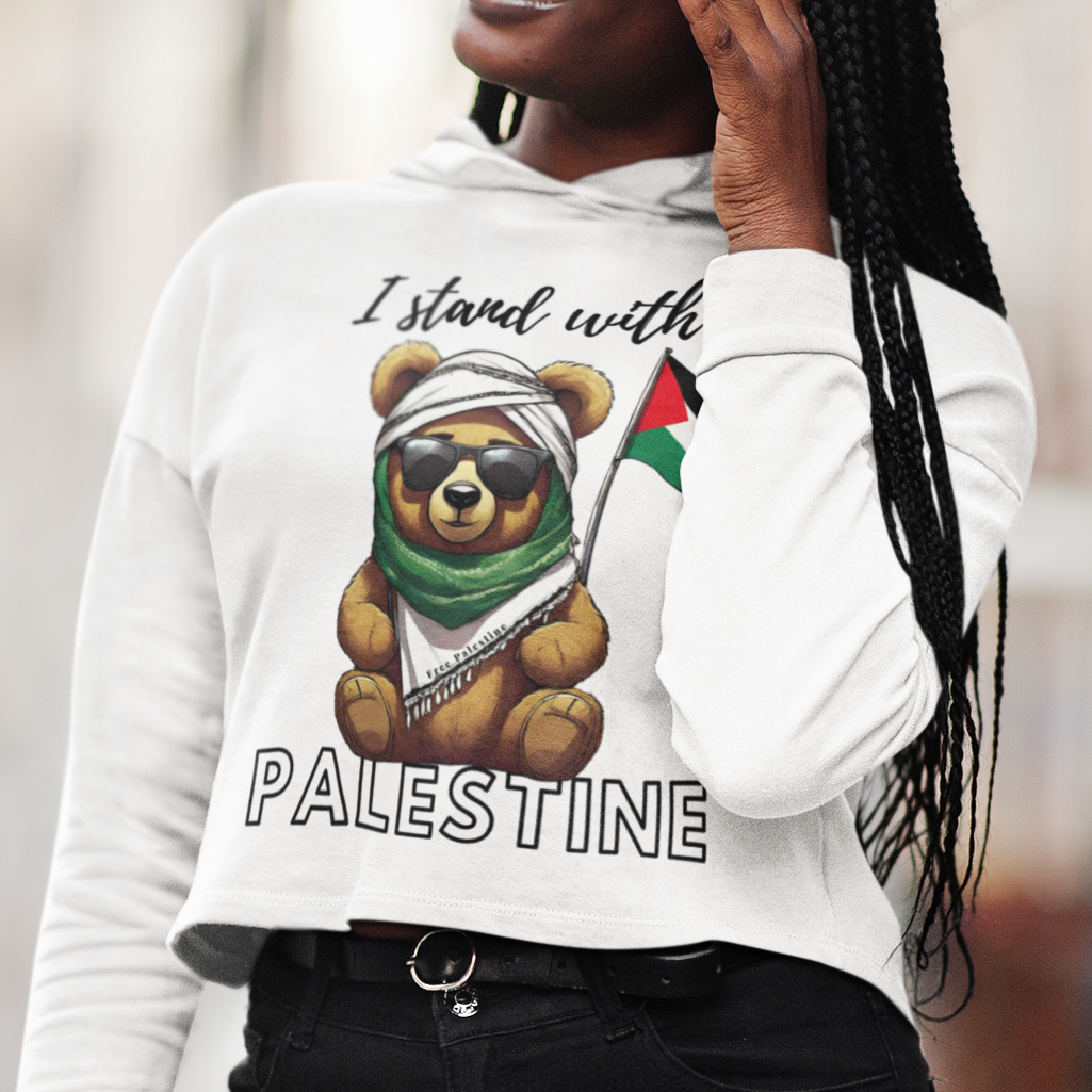 Person wearing a white sweatshirt with a bear holding a Palestinian flag design and 'I stand with Palestine' text.