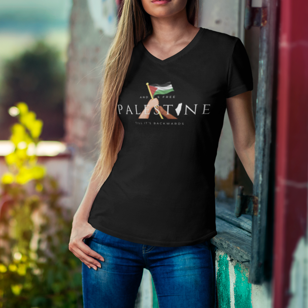Woman wearing a black t-shirt with a graphic design, standing outdoors with a scenic background.