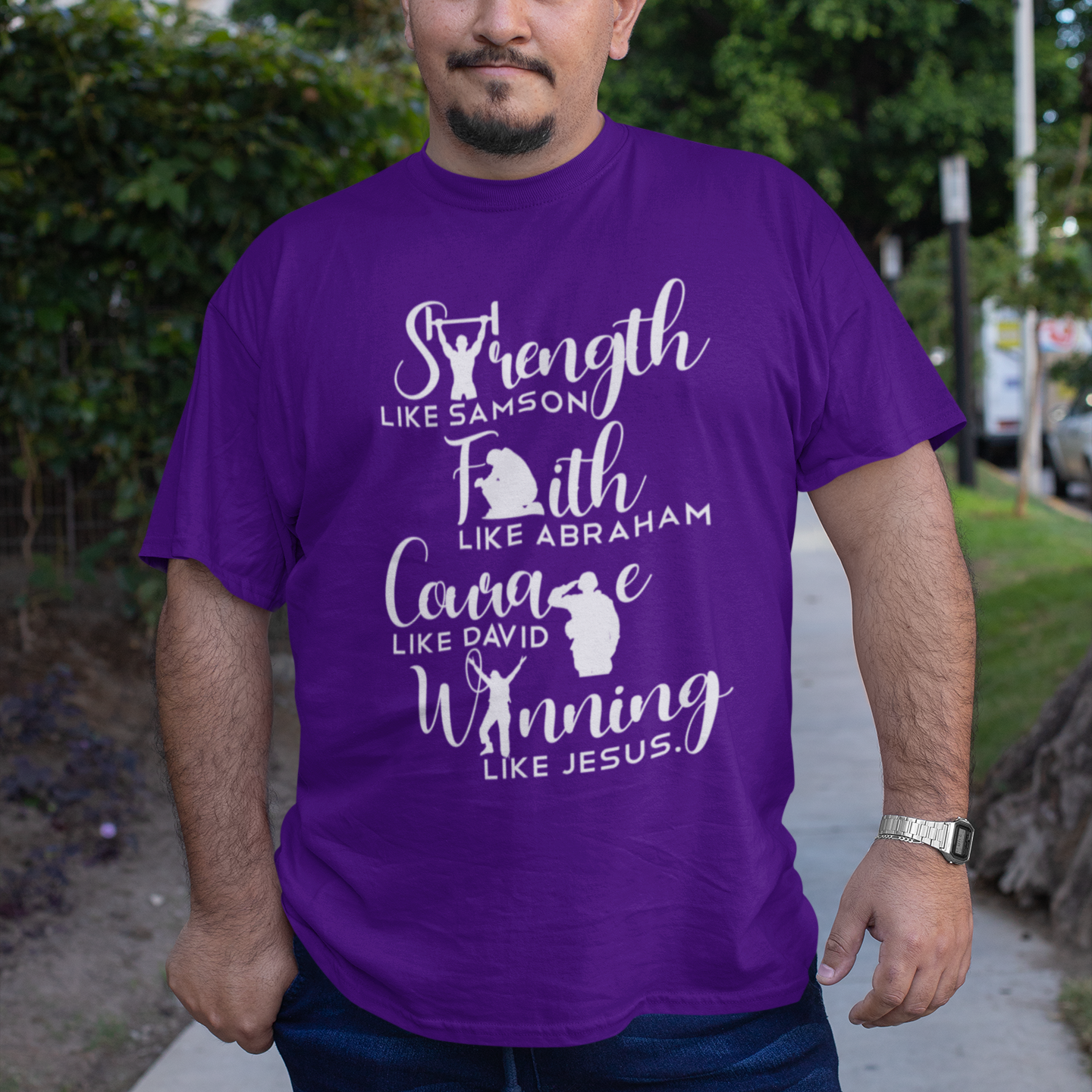 Man wearing a purple t-shirt with motivational text and character references, standing outdoors.