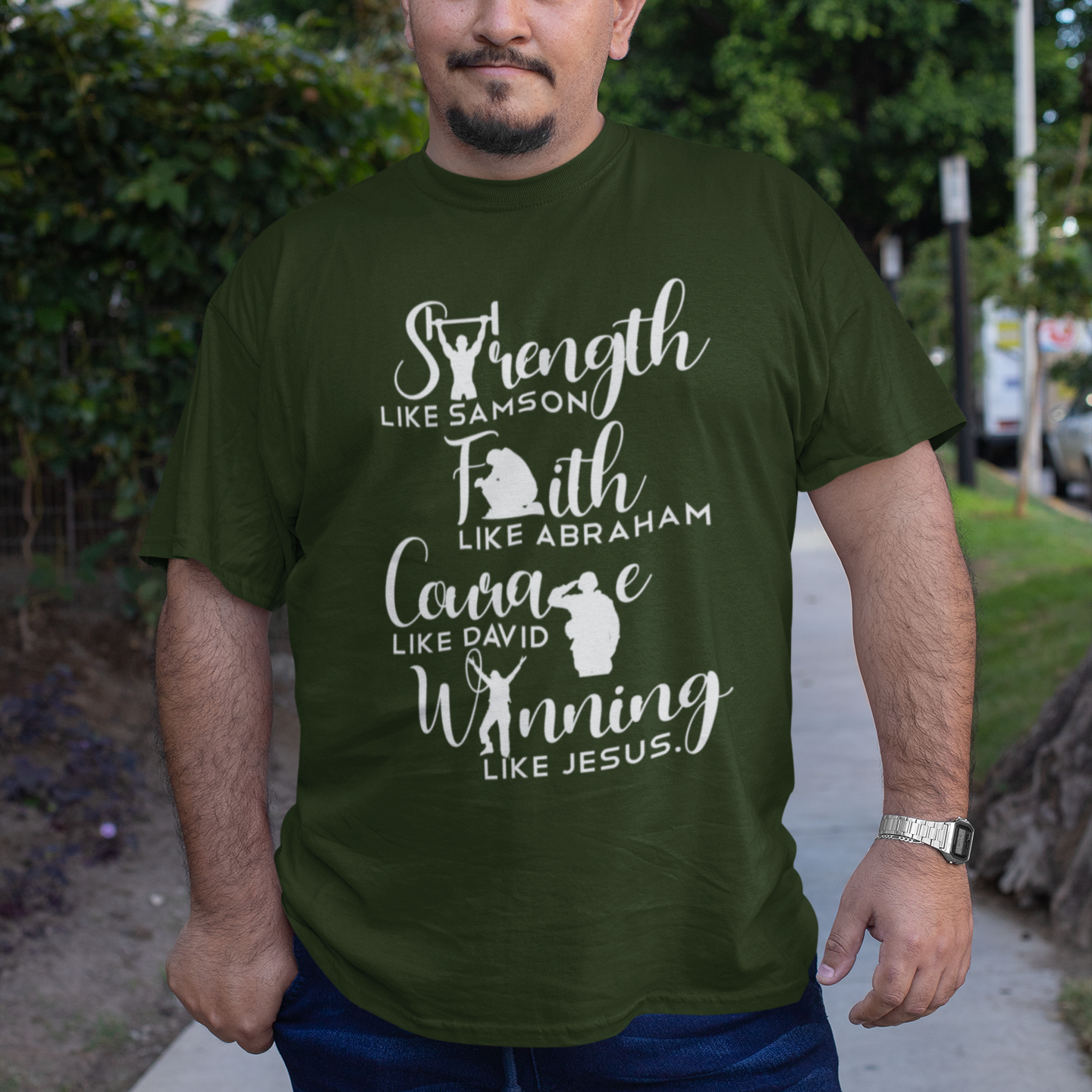 Man wearing a green t-shirt with motivational text on a sidewalk