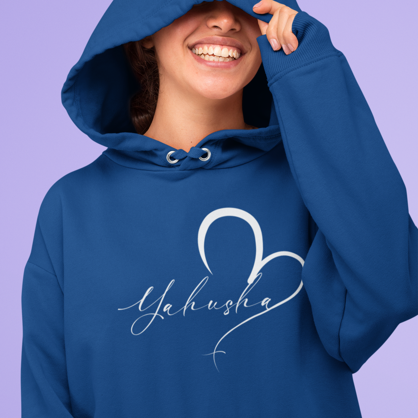 Person wearing a blue hoodie with 'Yahusha' design on a purple background