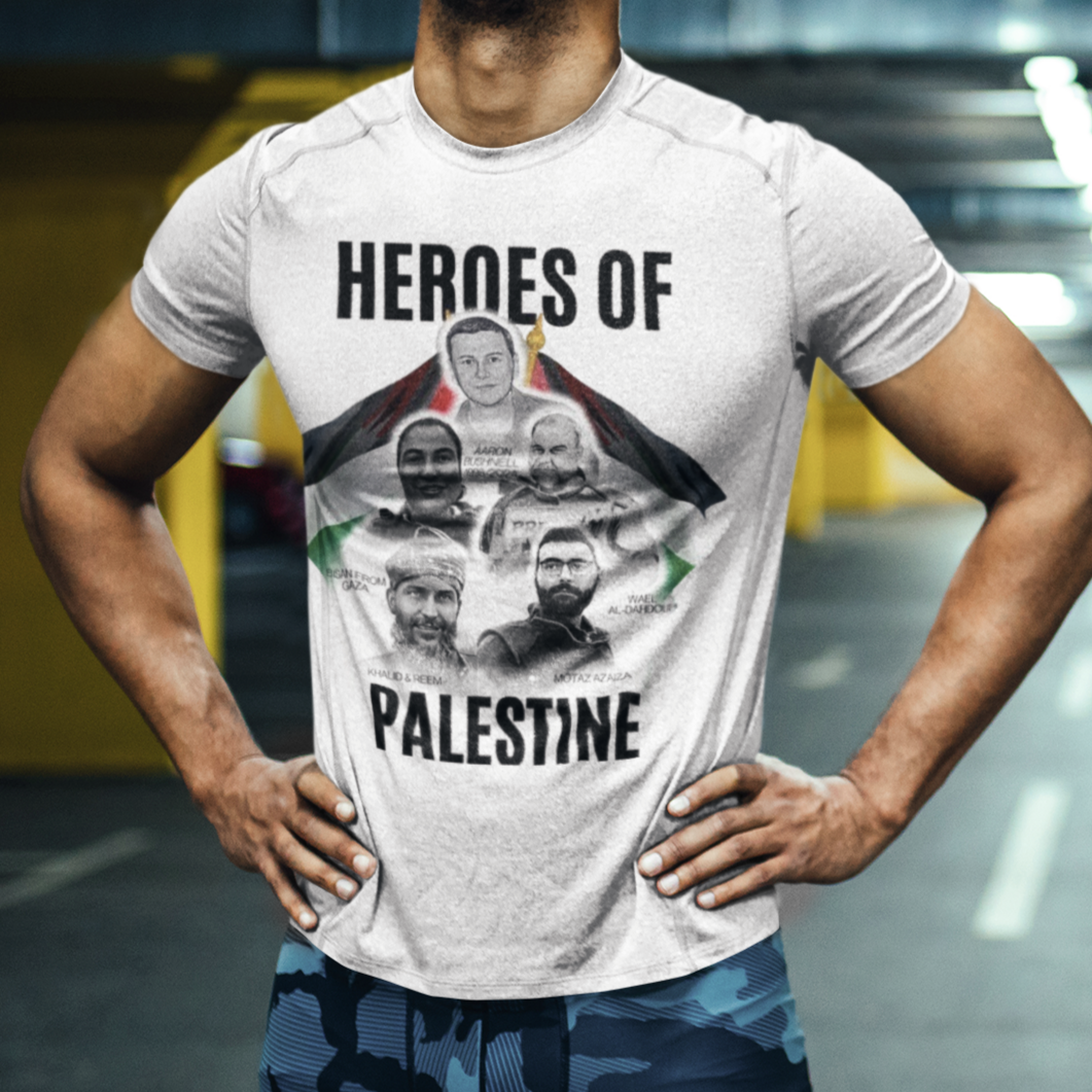 Man wearing a t-shirt with 'Heroes of Palestine' graphic in a parking garage.