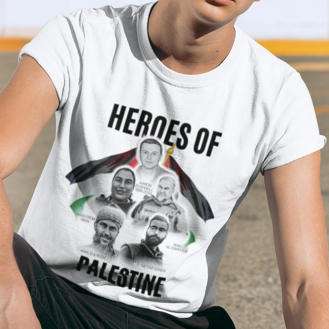 Person wearing a white t-shirt with 'Heroes of Palestine' graphic