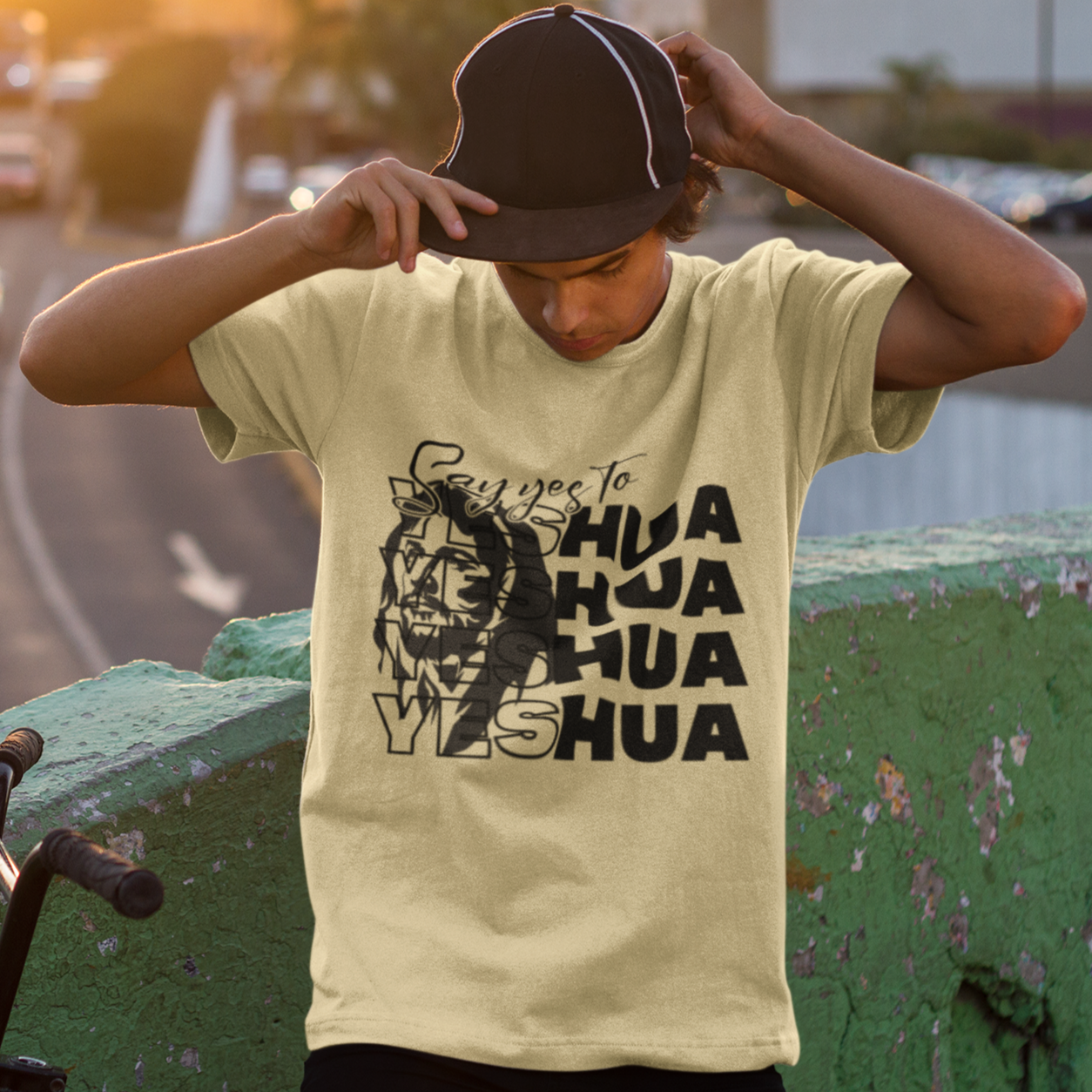 Person wearing a t-shirt with a graphic design on a street background
