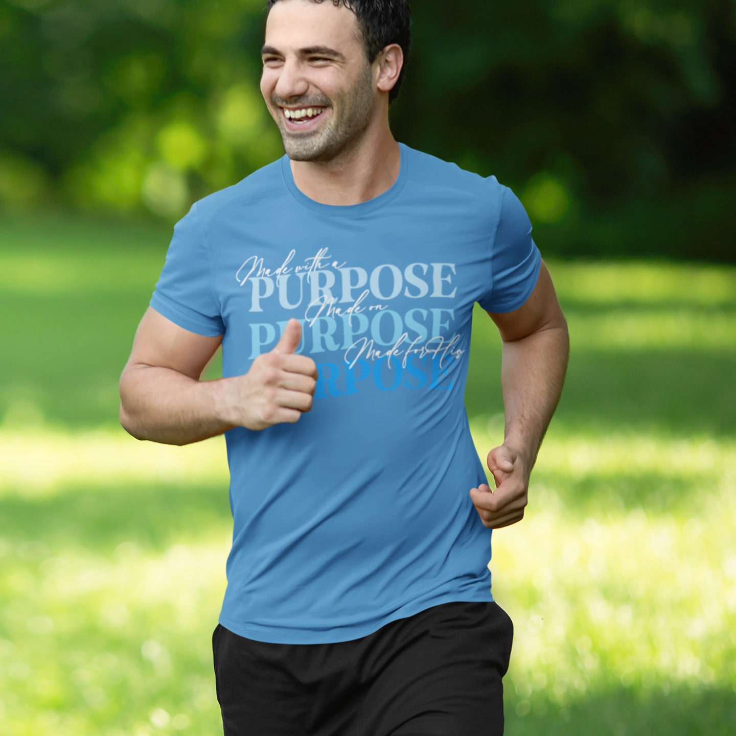Man running outdoors wearing a blue t-shirt with text
