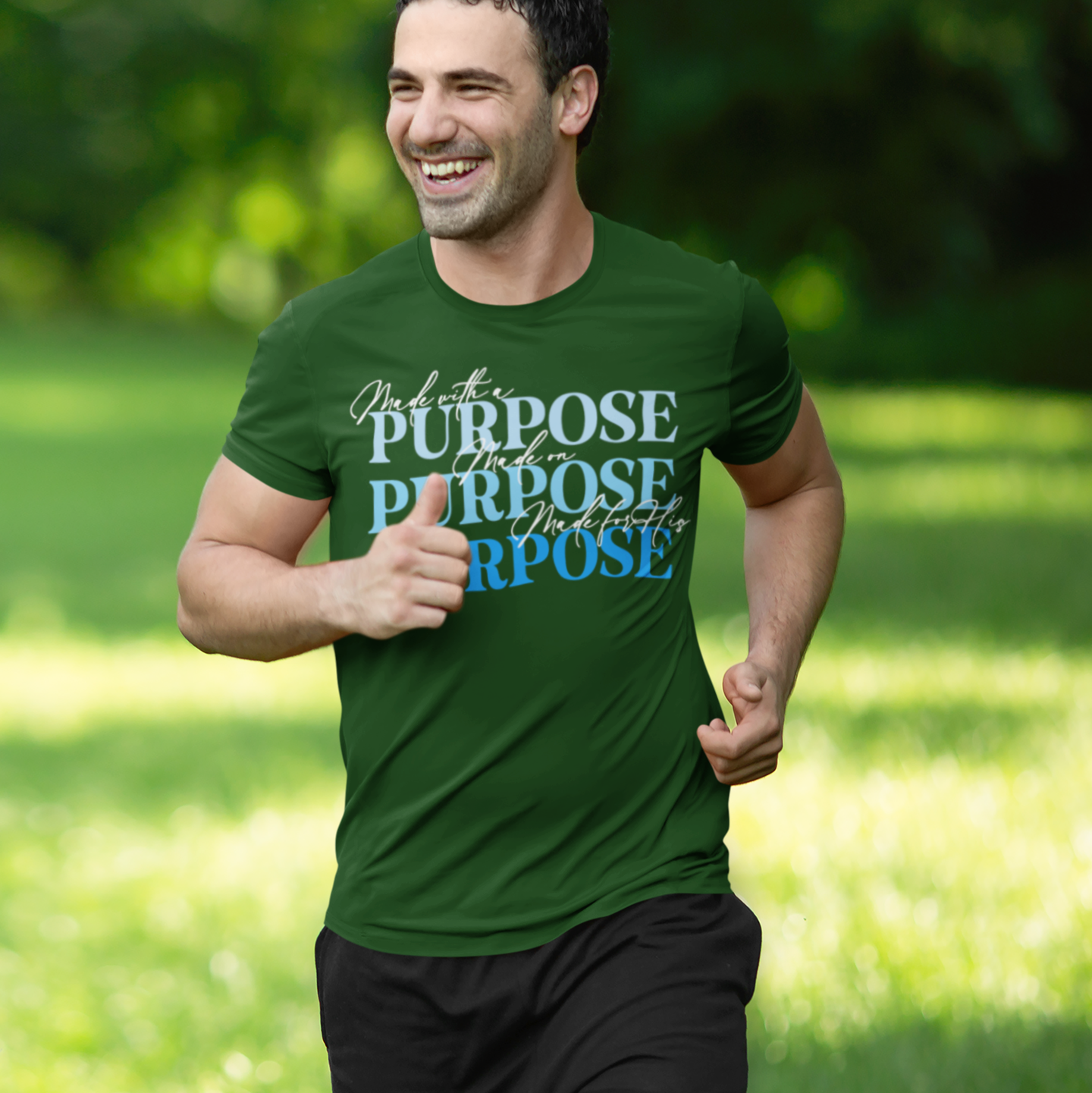 Man running outdoors wearing a green t-shirt with motivational text