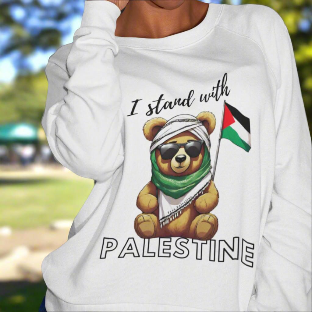 Person wearing a white sweatshirt with a bear graphic and 'I stand with Palestine' text.