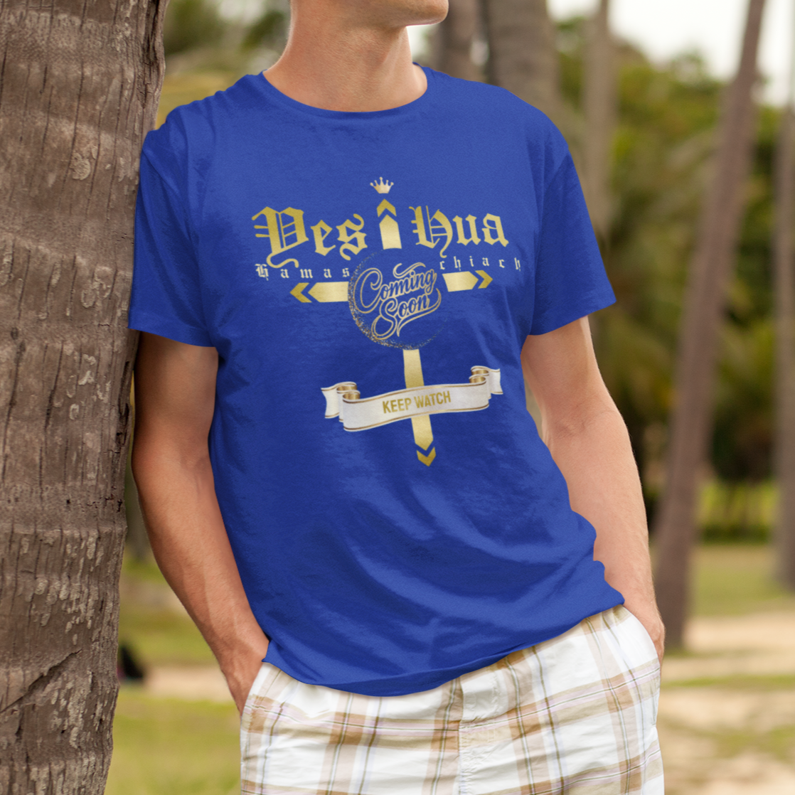 Person wearing a blue t-shirt with text and graphics, standing against a palm tree.