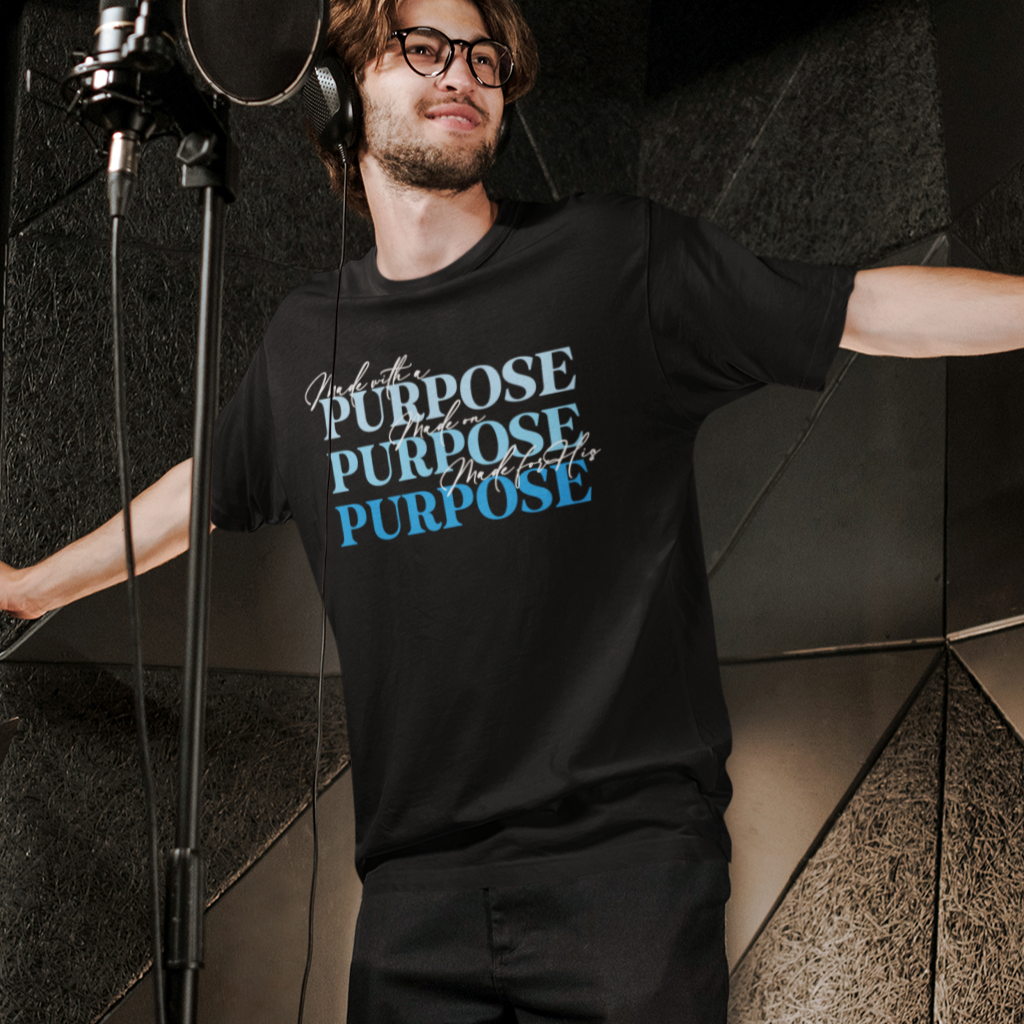 Person wearing a black t-shirt with 'PURPOSE' text in a studio setting