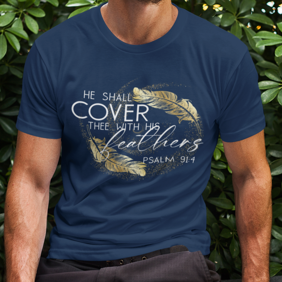 Man wearing a blue t-shirt with a design and text, sitting outdoors against green foliage.