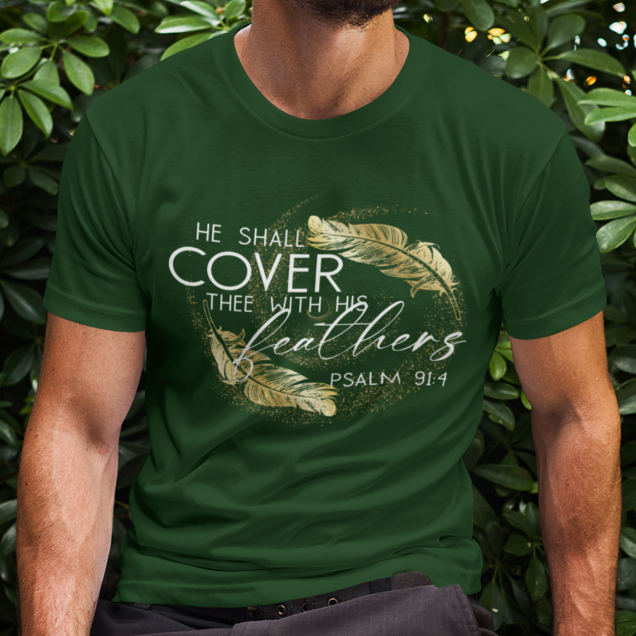Man wearing a green t-shirt with text and design, sitting in front of green foliage.
