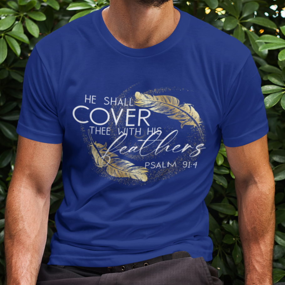 Man wearing a blue t-shirt with text and design, sitting outdoors among green bushes.