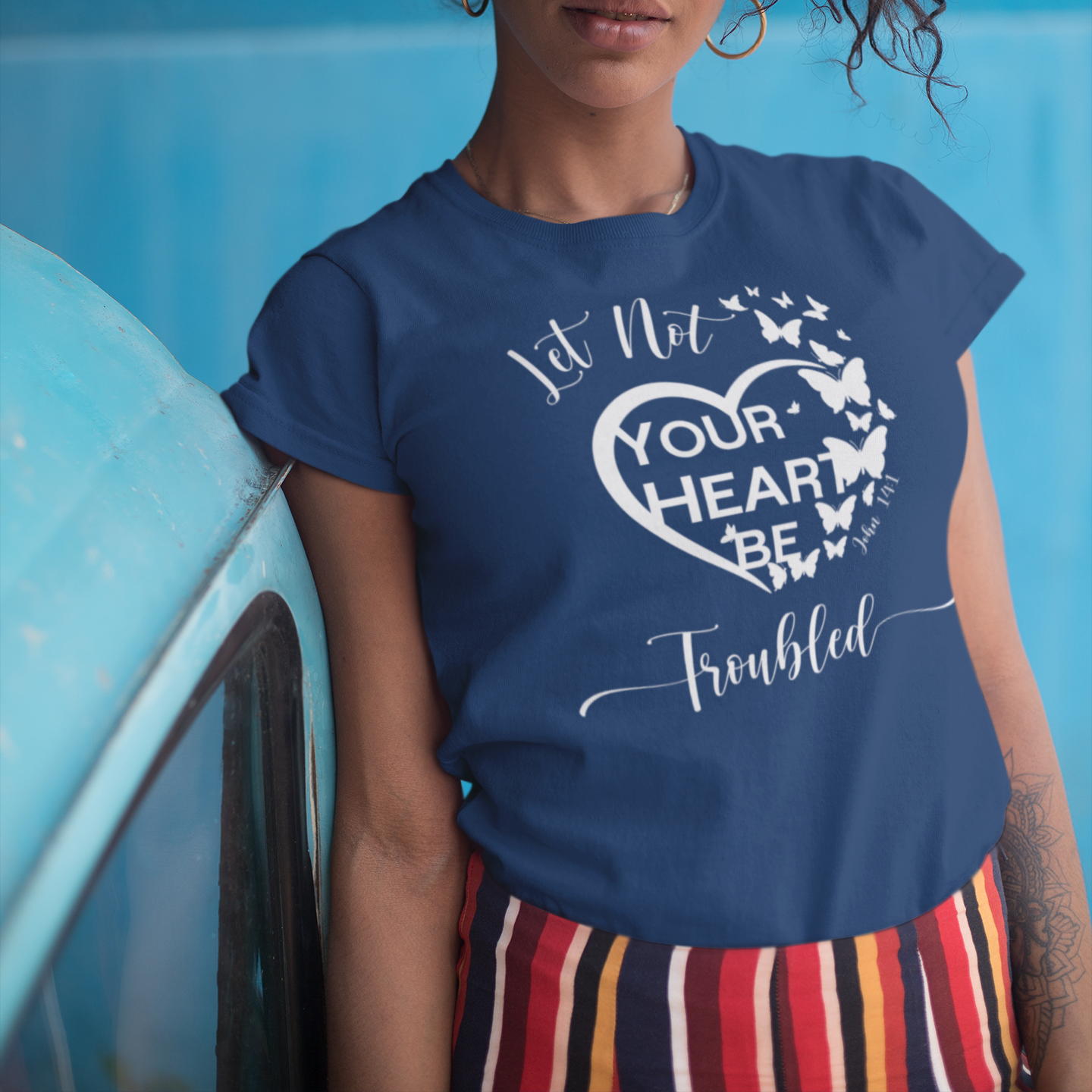 Woman wearing a blue t-shirt with a motivational quote against a blue background