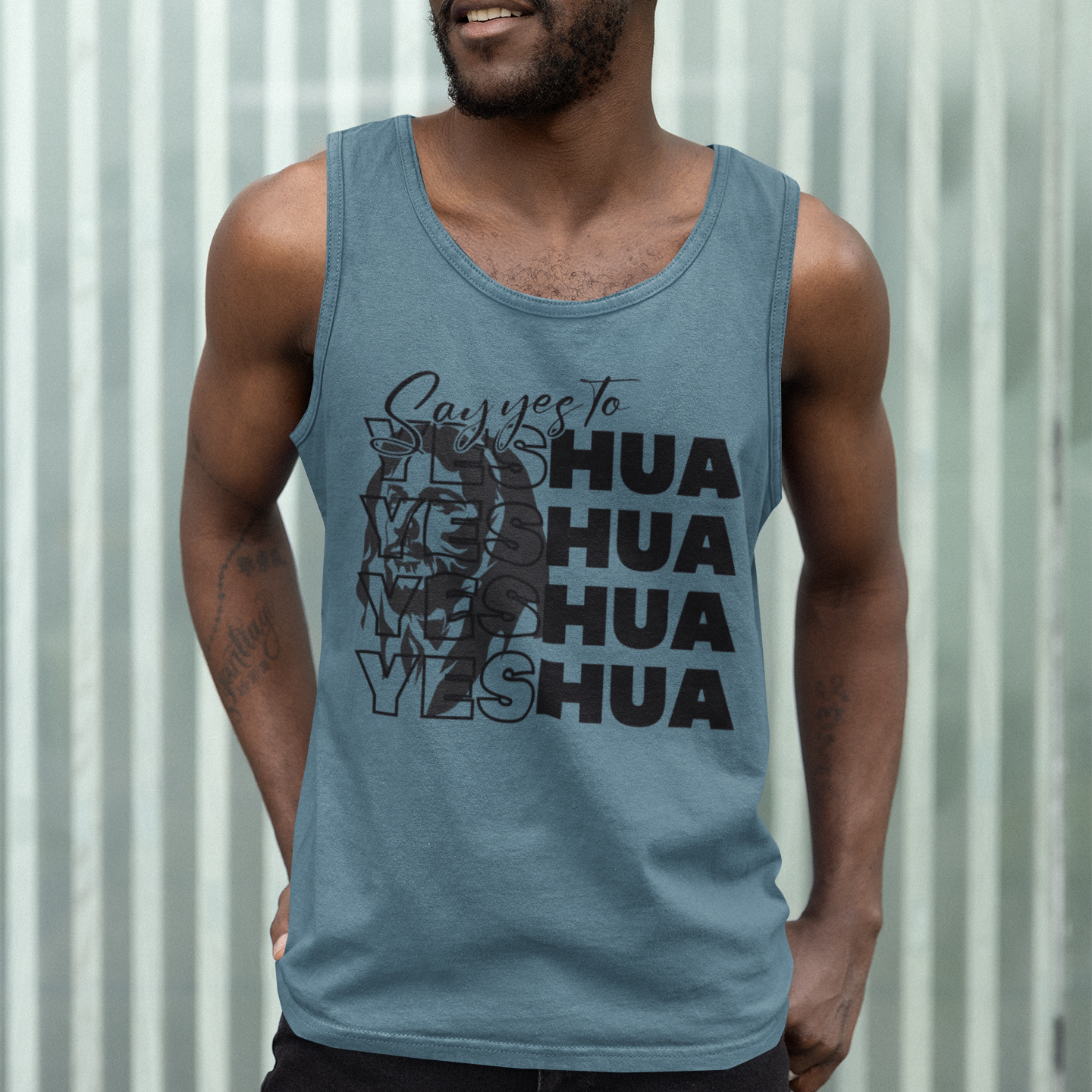 Man wearing a blue tank top with text and graphics against a corrugated metal background