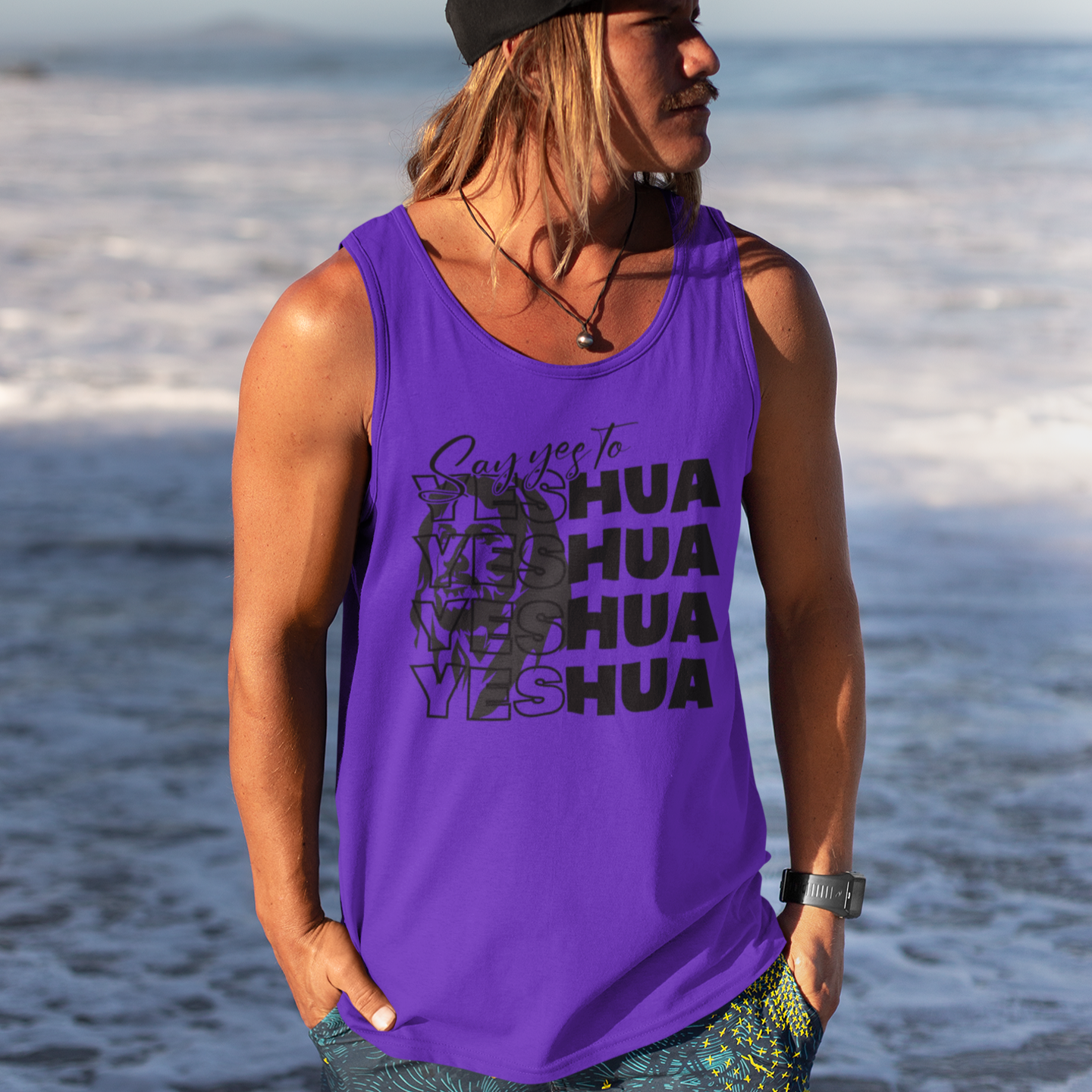 Person wearing a purple tank top with text on a beach