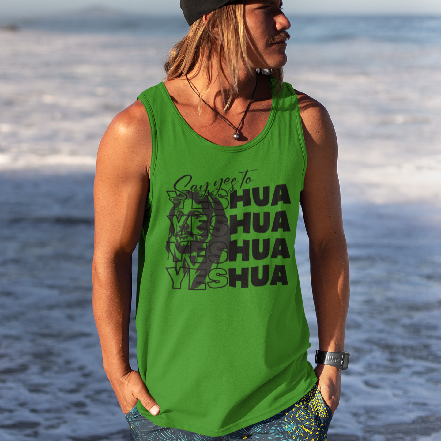 Person wearing a green tank top with text on a beach