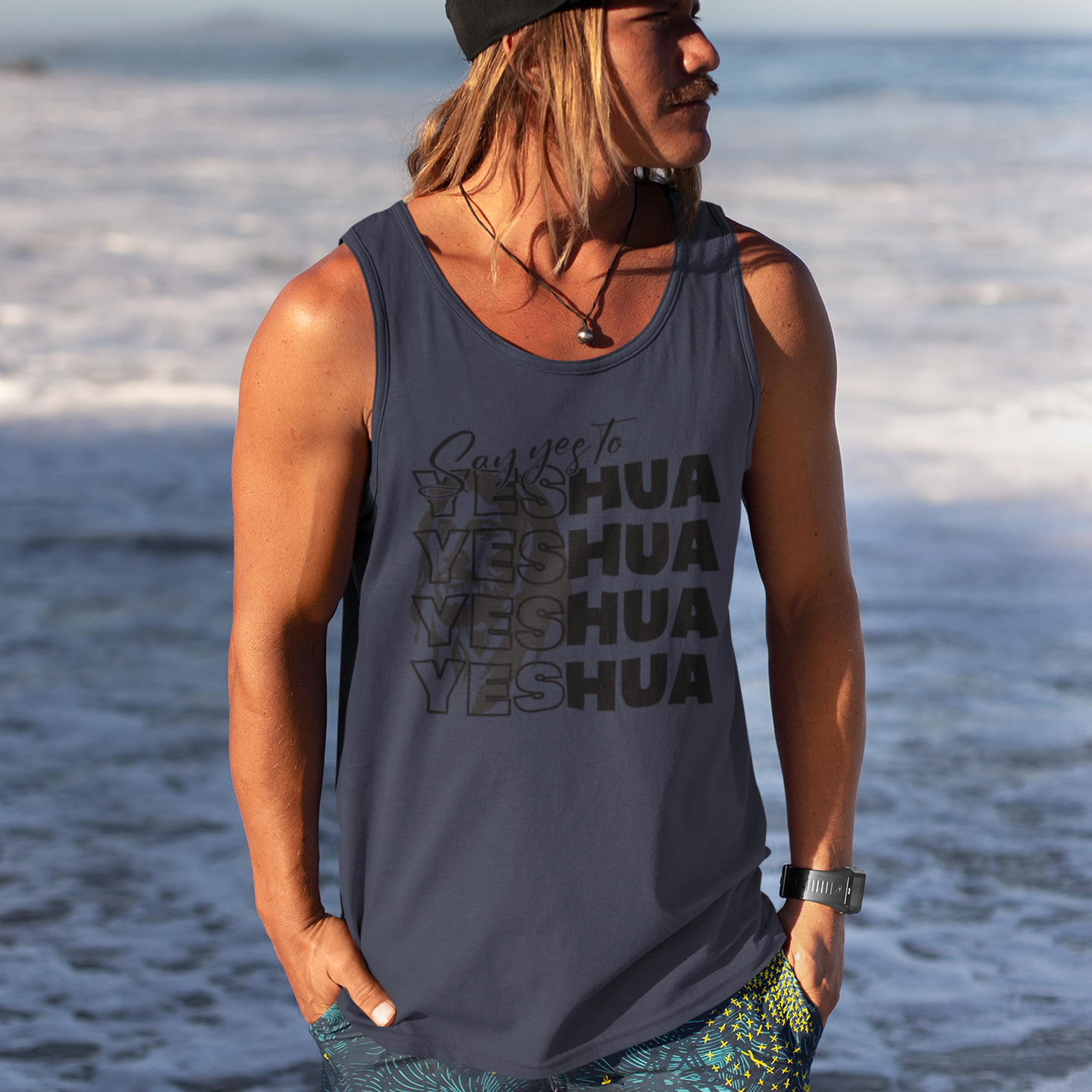 Person wearing a tank top with text on a beach