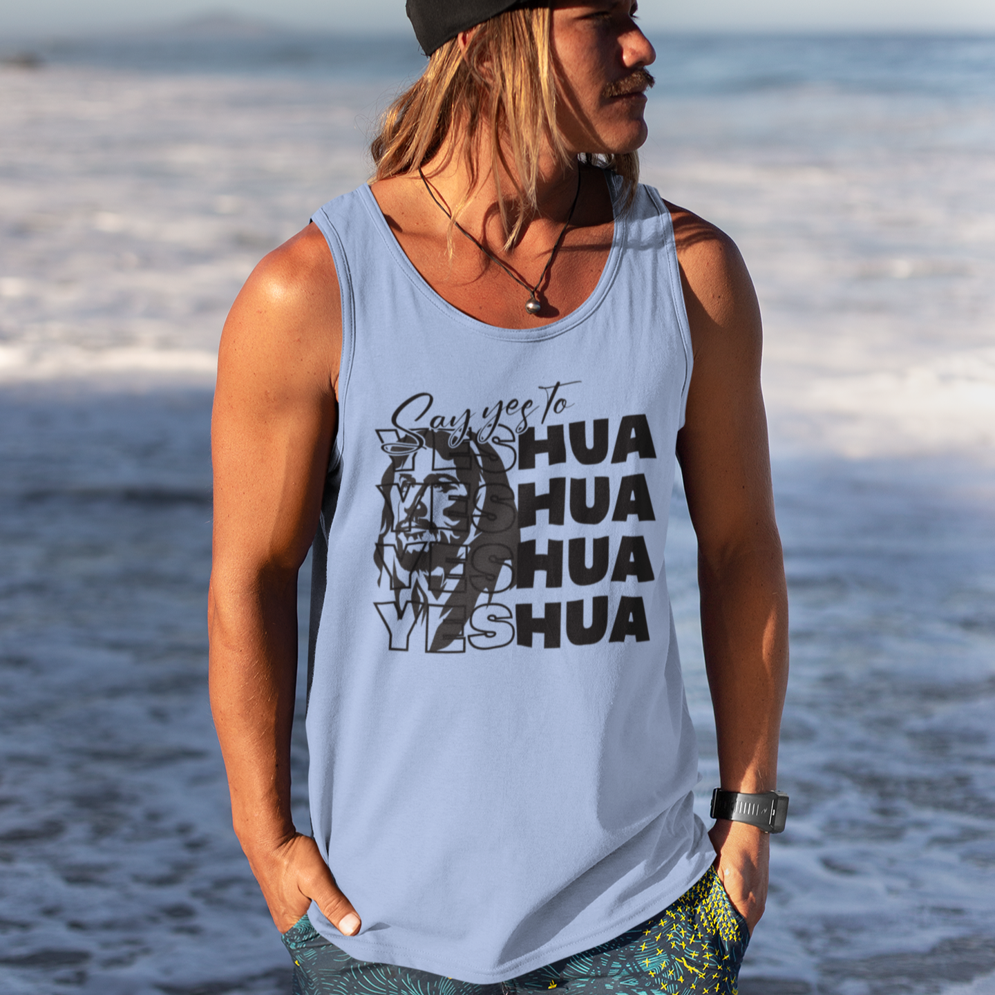 Person wearing a tank top with 'HUA HUA YASHA' text on a beach